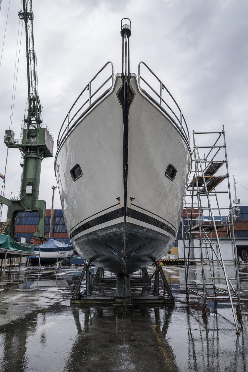 A yacht hull on cradle stands in a Singapore boatyard